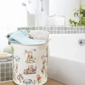 neutral nursery storage basket with cute bear design, white canvas laundry hamper for baby room organization, minimalist nursery decor idea