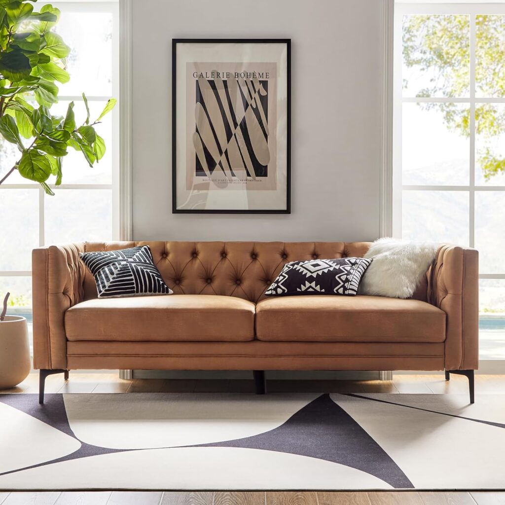 Mid-century modern faux leather sofa in camel with button tufting and sleek metal legs