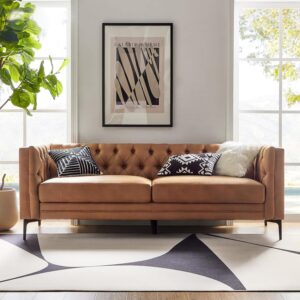 Mid-century modern faux leather sofa in camel with button tufting and sleek metal legs