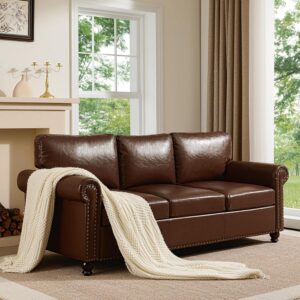 Dark brown mid-century modern leather sofa with rolled arms, nailhead trim, and hidden storage