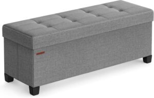 foldable storage ottoman bench in small living room for space saving organization