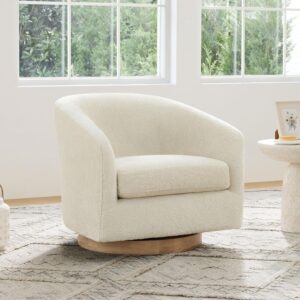 cream boucle swivel accent chair in modern living room with neutral decor
