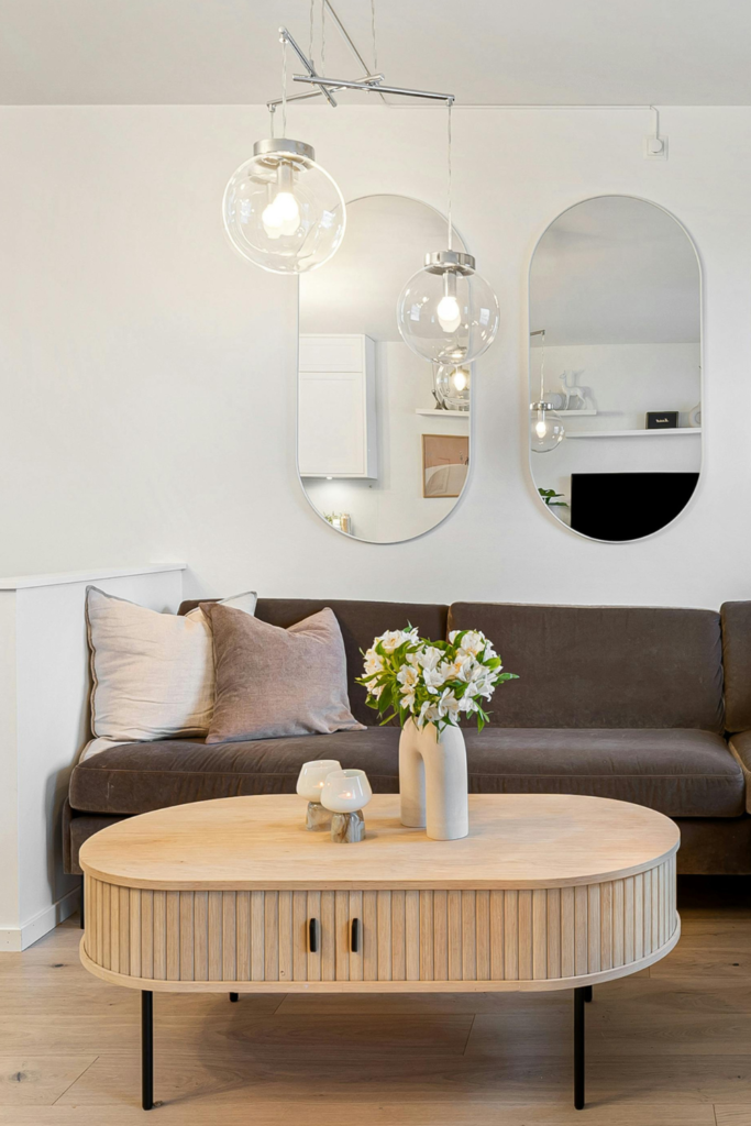 Rattan coffee table with storage in front of a sofa in a neutral living room