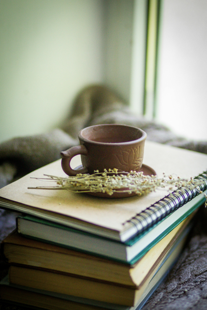 Books and a coffee cup displayed on a stylish bedroom nightstand