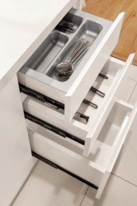 Organized kitchen drawers with utensil dividers and storage inserts