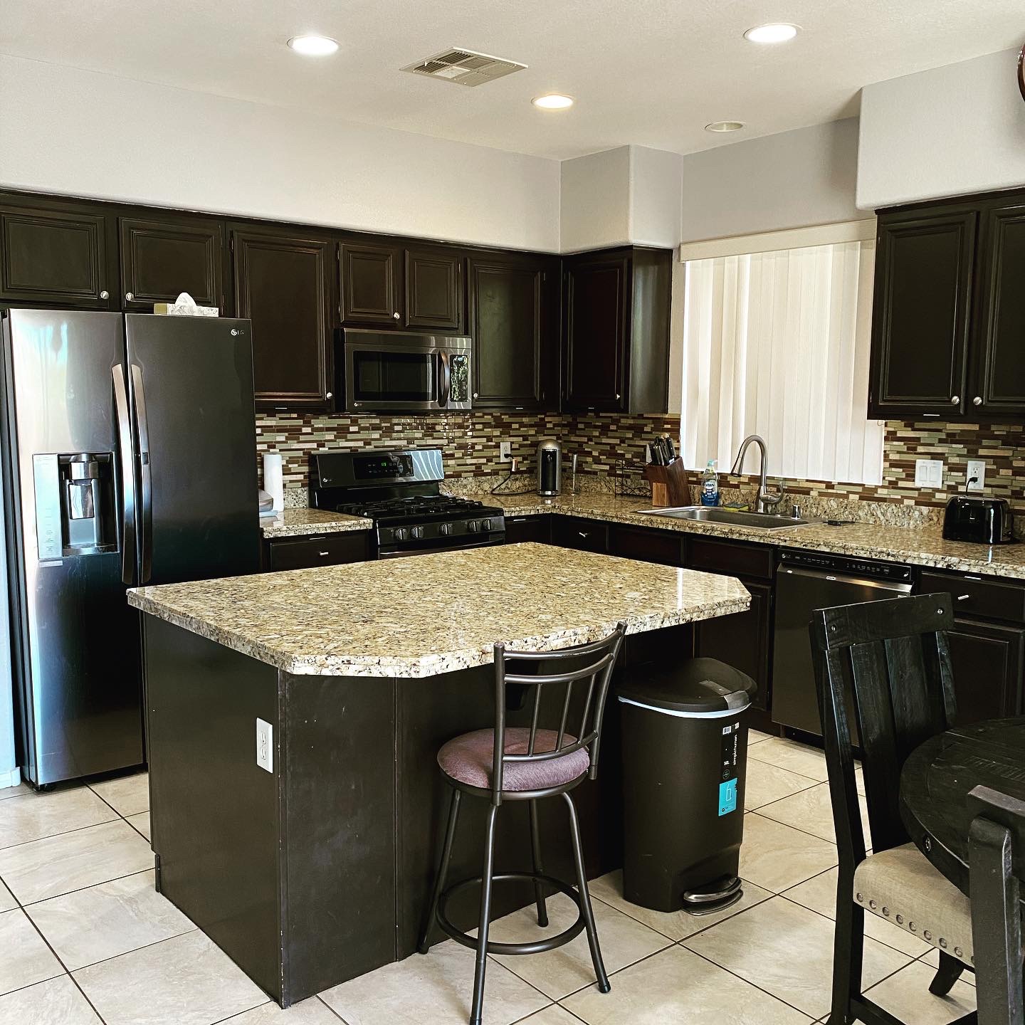 Beautiful organized kitchen featuring granite countertops, efficient storage, and clutter-free workspaces.