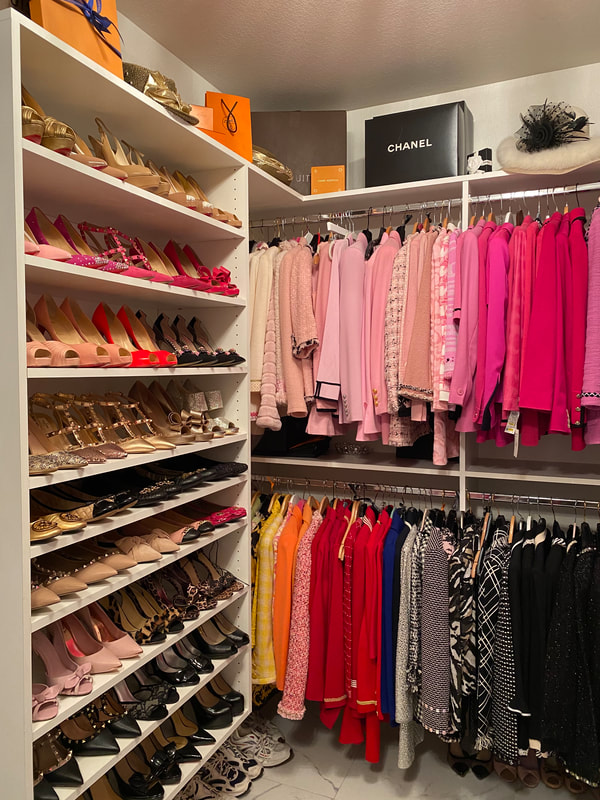 Organized walk-in closet with color-coordinated jackets, shoes, and storage designed for maximum efficiency.